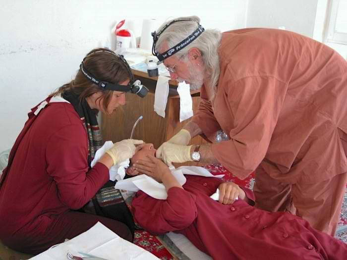 Dr. Rolfe and Volunteer Working on a Child's Teeth