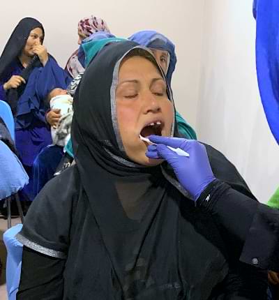 Examining a Mother's Teeth