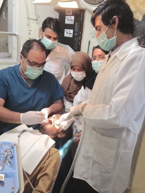 Dr. Kim Instructing Students On Teeth Cleaning Procedure